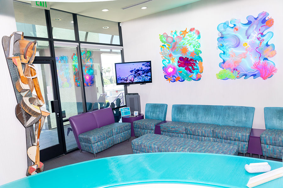 Make your self at home in our comfortable waiting room with vibrant neon art
